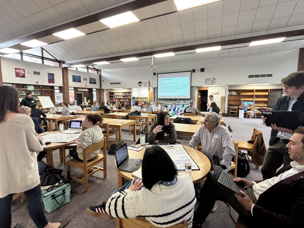 District educators working together at a Fuse AI session in a school library